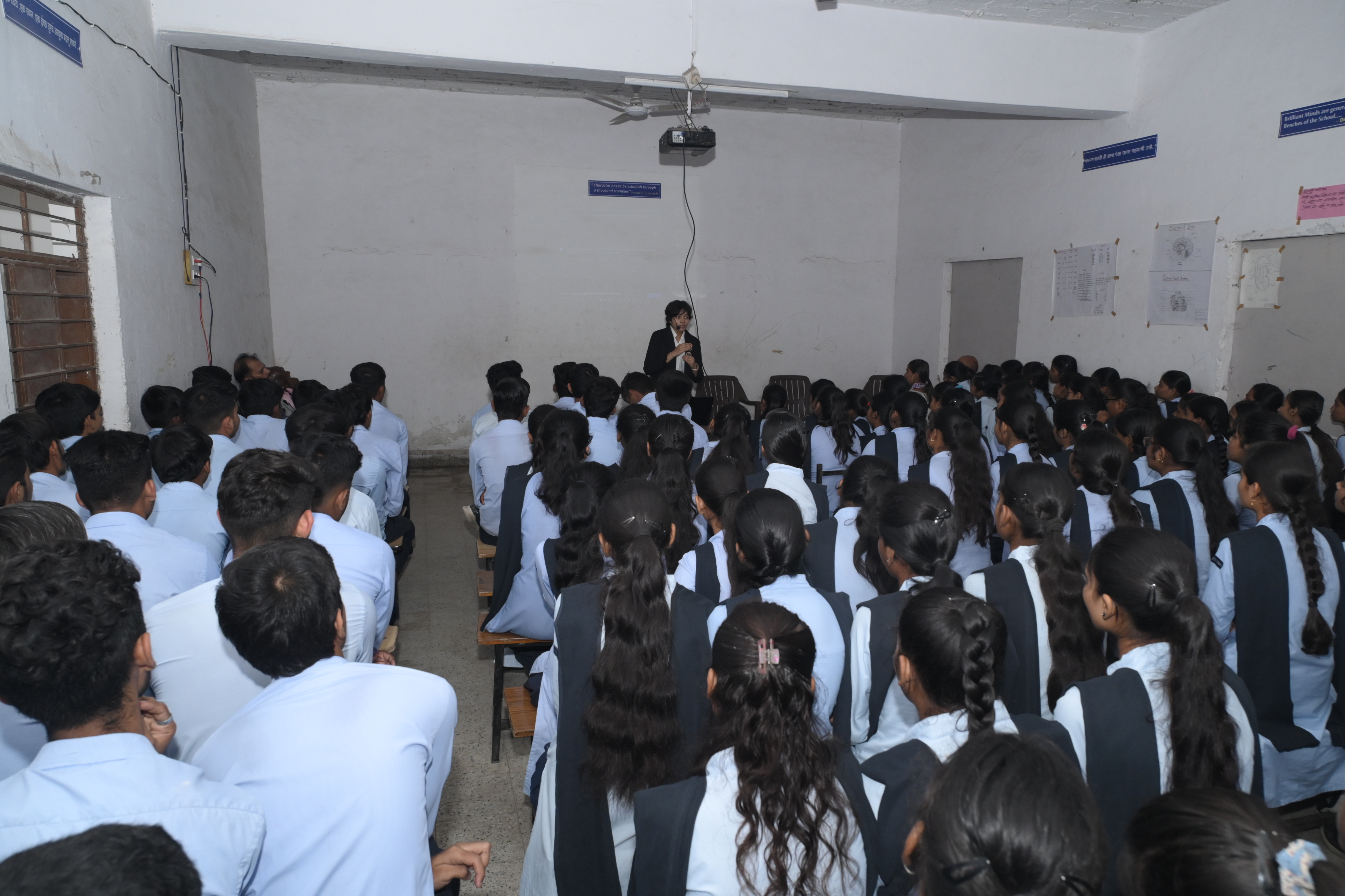 Angel Malewar delivering a technology seminar to a large student audience